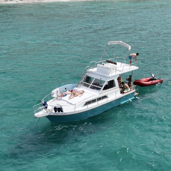 Boat in the crystal-clear waters of Menorca’s south coast